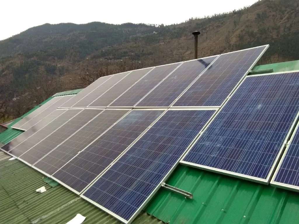 Solar panels on a green metal roof in Himachal
