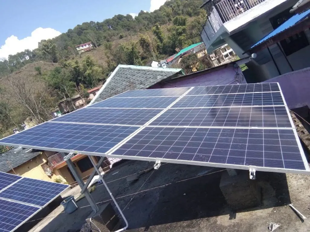 Ground-tilt solar panels overlooking a Himalayan valley